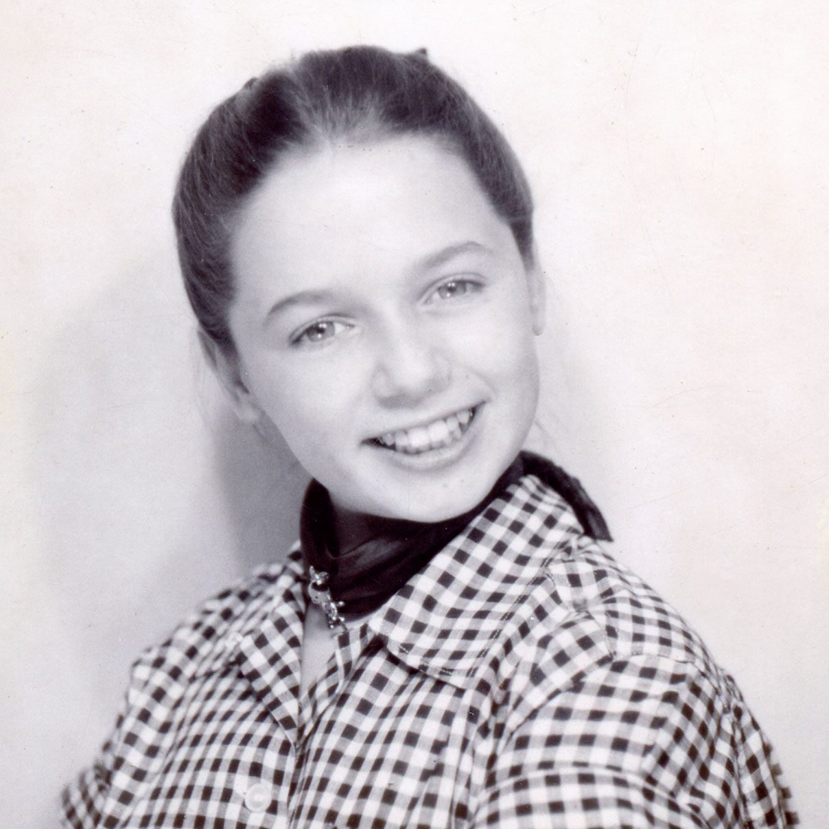 Young Ronnie Haran smiling in a checked shirt